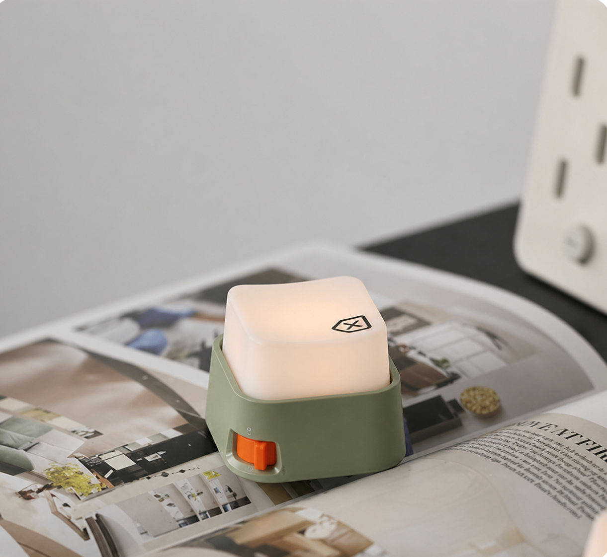 Small cube light on magazine book setting. Chill vibes, room decor